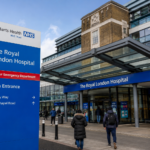 Royal London Hospital main entrance in Whitechapel with visitors entering the modern NHS hospital building.