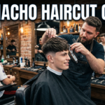 Professional barber creating a Garnacho haircut with a clean mid fade and textured top in a modern barbershop.