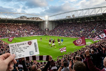 Hearts FC fans cheering inside Tynecastle Park stadium during a football match